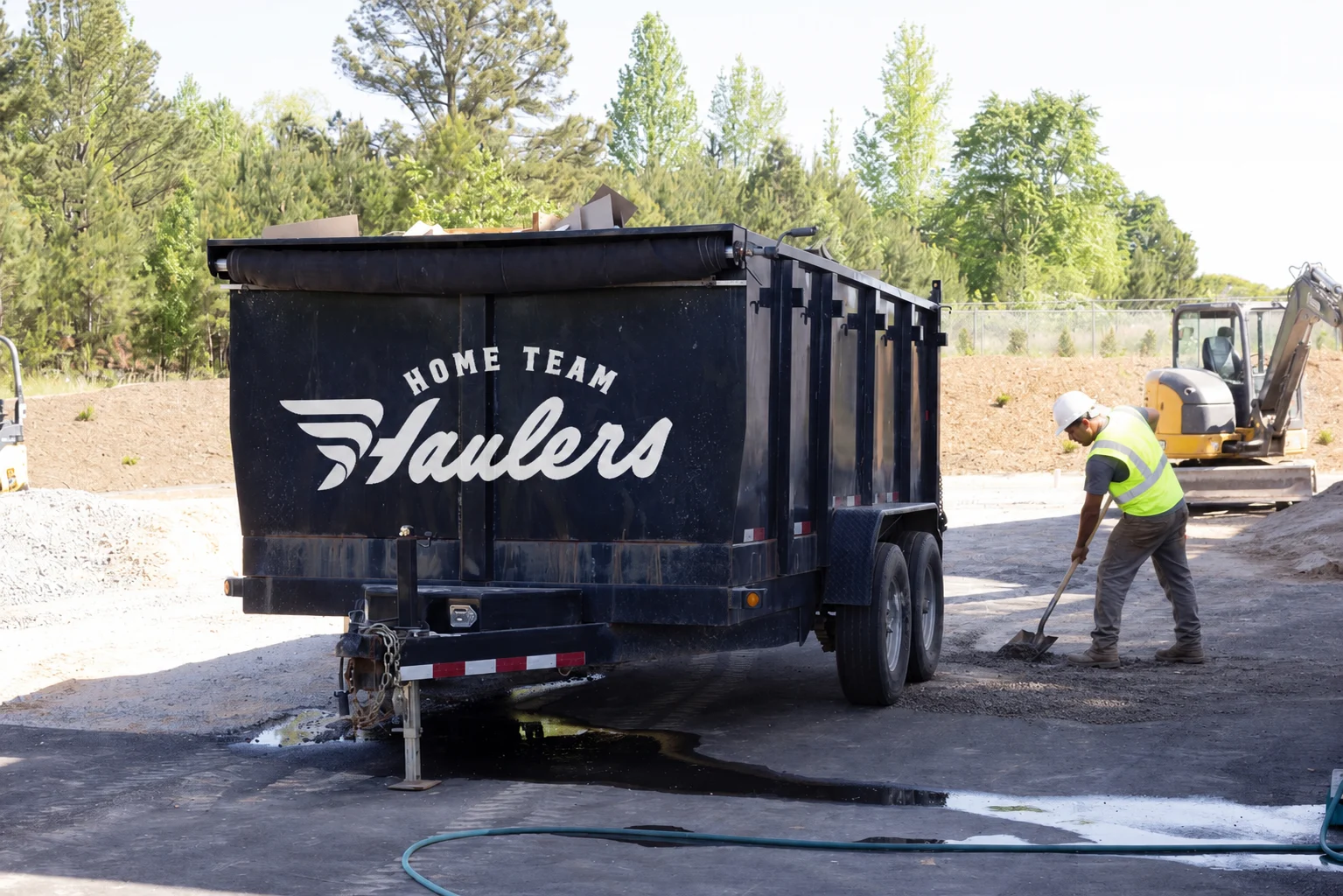 dump trailer with construction worker